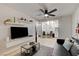 Modern living room features a ceiling fan, floating shelves, TV, and an open floor plan with easy kitchen access at 4200 S Valley View Blvd # 2085, Las Vegas, NV 89103