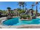 Refreshing pool with rock waterfall feature surrounded by tropical palm trees at 4200 S Valley View Blvd # 2085, Las Vegas, NV 89103