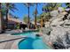 Sparkling pool with rock features and swaying palms for a tropical ambiance at 4200 S Valley View Blvd # 2085, Las Vegas, NV 89103