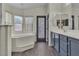 Bright bathroom boasts a soaking tub by the window and a vanity with plenty of storage space at 4537 Colonial Canyon St, North Las Vegas, NV 89031