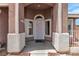 Covered front porch with decorative columns leading to a secure front door at 4537 Colonial Canyon St, North Las Vegas, NV 89031