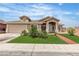 Inviting home with a two-car garage, lush green lawn, and well-kept landscaping at 4537 Colonial Canyon St, North Las Vegas, NV 89031
