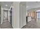 Hallway view leading to the kitchen with gray wood-look flooring and neutral paint at 4537 Colonial Canyon St, North Las Vegas, NV 89031