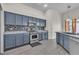 Kitchen featuring blue cabinets, stainless steel appliances, and modern backsplash at 4537 Colonial Canyon St, North Las Vegas, NV 89031