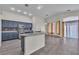 Open-concept kitchen with blue cabinets, stainless steel appliances, and adjacent living area at 4537 Colonial Canyon St, North Las Vegas, NV 89031
