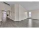 Bright, open living room with gray wood-look flooring and natural light from the window at 4537 Colonial Canyon St, North Las Vegas, NV 89031