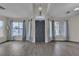 Bright living room features many windows, tall ceilings, and modern grey floors at 4537 Colonial Canyon St, North Las Vegas, NV 89031