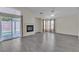 Bright living room featuring a cozy fireplace and sliding glass door with views of the backyard at 4537 Colonial Canyon St, North Las Vegas, NV 89031