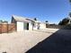 Spacious backyard featuring a fence, a low block wall, and a covered patio at 4651 Wild Oak Way, North Las Vegas, NV 89031