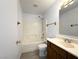 Bathroom with vanity, sink, toilet, tub, and a shower with white tiles at 4651 Wild Oak Way, North Las Vegas, NV 89031