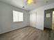 Bedroom with wood-style floors, a window with blinds, and a closet with sliding doors at 4651 Wild Oak Way, North Las Vegas, NV 89031