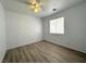 Comfortable bedroom featuring a ceiling fan, wood-style floors, and a window with blinds at 4651 Wild Oak Way, North Las Vegas, NV 89031