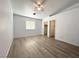 Bedroom with hard surface floors, closet and a ceiling fan with natural light at 4651 Wild Oak Way, North Las Vegas, NV 89031