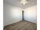 Empty bedroom featuring wood grain floors, neutral paint and closet with sliding doors at 4651 Wild Oak Way, North Las Vegas, NV 89031