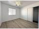Bedroom with wood grain floors, neutral paint and a ceiling fan at 4651 Wild Oak Way, North Las Vegas, NV 89031