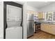 Well-lit kitchen featuring stainless steel appliances, and adjacent to a stackable washer and dryer at 5250 S Rainbow Blvd # 2070, Las Vegas, NV 89118