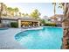 Resort-style pool area with a hot tub, palm trees, lounge chairs, and a shaded seating area at 5250 S Rainbow Blvd # 2070, Las Vegas, NV 89118