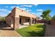 Charming backyard featuring a covered patio, artificial turf, and decorative gravel at 5384 Candlespice Way, Las Vegas, NV 89135