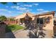 Spacious backyard features desert landscaping with an extended patio, artificial turf, and ample space for outdoor activities at 5384 Candlespice Way, Las Vegas, NV 89135
