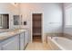 The primary bathroom features dual vanities, a soaking tub, and a separate walk-in closet at 5384 Candlespice Way, Las Vegas, NV 89135