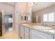 Bathroom featuring dual sinks, a large mirror, and a separate shower at 5384 Candlespice Way, Las Vegas, NV 89135