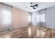 Light and bright bedroom with wood-look floors, ceiling fan, and large windows at 5384 Candlespice Way, Las Vegas, NV 89135