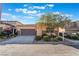 Inviting single-story home featuring a two-car garage, landscaped front yard, and stone accents at 5384 Candlespice Way, Las Vegas, NV 89135