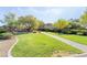 Expansive green space with a sidewalk and playground, providing a serene outdoor environment at 5384 Candlespice Way, Las Vegas, NV 89135