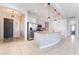 A spacious kitchen with stainless steel appliances, large island with seating, and ample cabinet space at 5384 Candlespice Way, Las Vegas, NV 89135