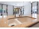 A stainless steel kitchen sink with view of the backyard from the adjacent sliding glass doors at 5384 Candlespice Way, Las Vegas, NV 89135