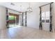 Bright living room with tile floors and stylish curtains, adjacent to the backyard patio at 5384 Candlespice Way, Las Vegas, NV 89135