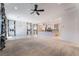Expansive living space with carpet and tile, featuring an open layout and modern lighting fixtures at 5384 Candlespice Way, Las Vegas, NV 89135