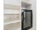 Walk-in pantry featuring white shelving and wine cooler for storing all of your favorite items at 5384 Candlespice Way, Las Vegas, NV 89135