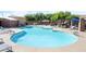Large community pool with clear blue water, lounge chairs, and shaded seating areas for residents at 5384 Candlespice Way, Las Vegas, NV 89135