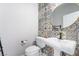 Modern powder room featuring decorative tile accent wall and pedestal sink at 5384 Candlespice Way, Las Vegas, NV 89135