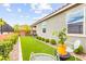 Cozy backyard features lush artificial turf, manicured shrubs, and a relaxing seating area at 5530 Hill Spire St, Las Vegas, NV 89166