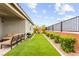 Beautifully landscaped backyard featuring artificial grass and a cozy outdoor seating area at 5530 Hill Spire St, Las Vegas, NV 89166