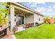 Backyard with covered patio, artificial grass, and outdoor seating area at 5530 Hill Spire St, Las Vegas, NV 89166