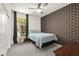 Cozy bedroom with geometric accent wall, ceiling fan, and ample natural light at 5530 Hill Spire St, Las Vegas, NV 89166