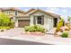 Well-maintained single-story home with a two-car garage, stone accents, and mature landscaping at 5530 Hill Spire St, Las Vegas, NV 89166