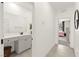 Hallway with a bathroom vanity with granite countertops and grey cabinets at 5530 Hill Spire St, Las Vegas, NV 89166