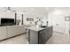 Modern kitchen island seamlessly connects to the living area with sleek countertops and stylish barstools at 5530 Hill Spire St, Las Vegas, NV 89166