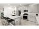 Modern kitchen features white cabinets, stainless steel appliances, and a large island with seating at 5530 Hill Spire St, Las Vegas, NV 89166