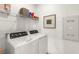 Functional laundry area equipped with modern washer, dryer, and shelving at 5530 Hill Spire St, Las Vegas, NV 89166