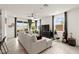 Bright living room with large windows, neutral decor, and comfortable seating area at 5530 Hill Spire St, Las Vegas, NV 89166