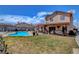 A sparkling backyard pool with a covered patio and a spacious grassy area at 5731 Fonchester Ct, Las Vegas, NV 89110
