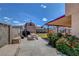Large backyard with vibrant flowers, patio, barn, and a secure block fence at 5731 Fonchester Ct, Las Vegas, NV 89110