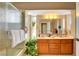 Bathroom featuring a double vanity, plant accents, and a shower with textured glass at 5731 Fonchester Ct, Las Vegas, NV 89110