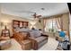 Comfortable bedroom featuring a unique wooden bed frame, ceiling fan, and neutral colored walls at 5731 Fonchester Ct, Las Vegas, NV 89110
