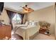 Bedroom featuring a ceiling fan, neutral walls, and a comfortable bed with decorative pillows at 5731 Fonchester Ct, Las Vegas, NV 89110